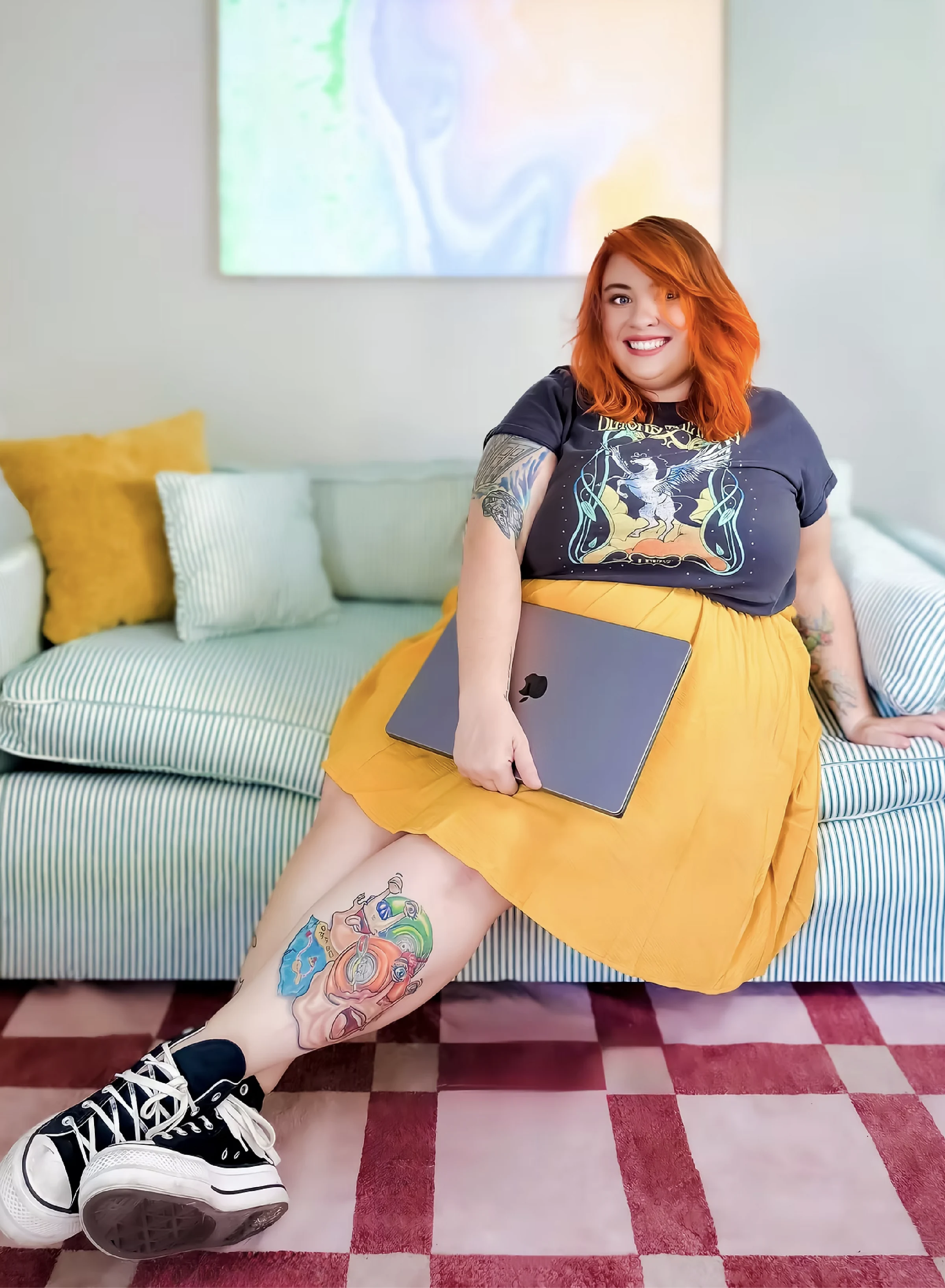 Lendi smiling with her laptop